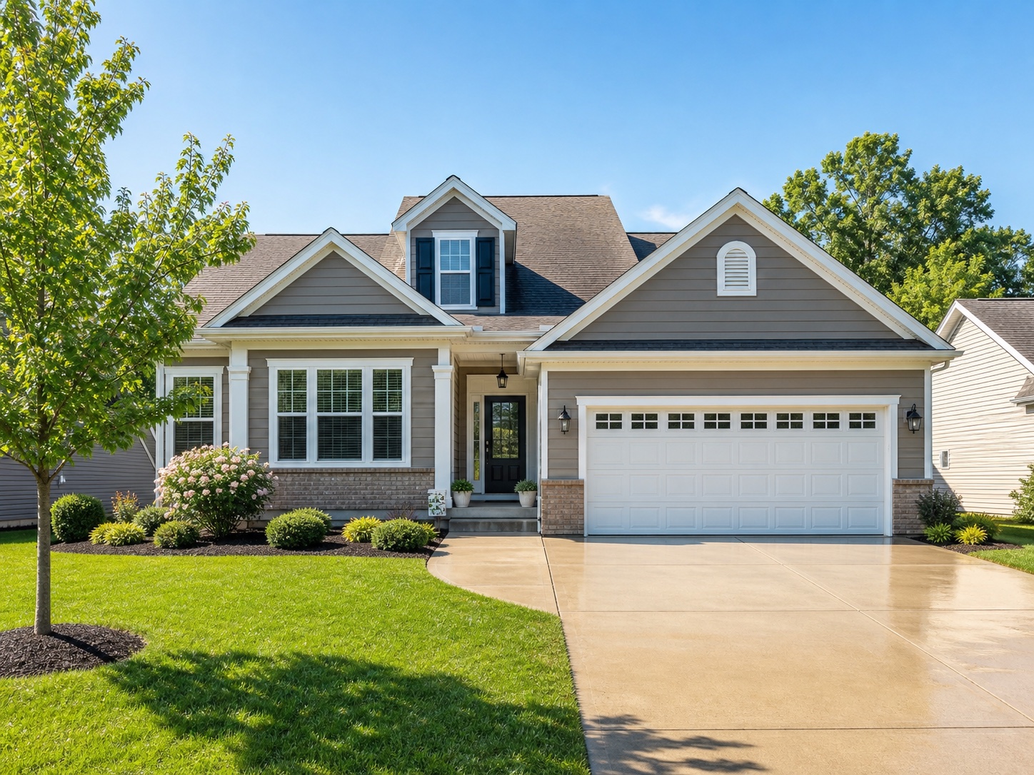 Clean house exterior with freshly washed driveway and bright curb appeal